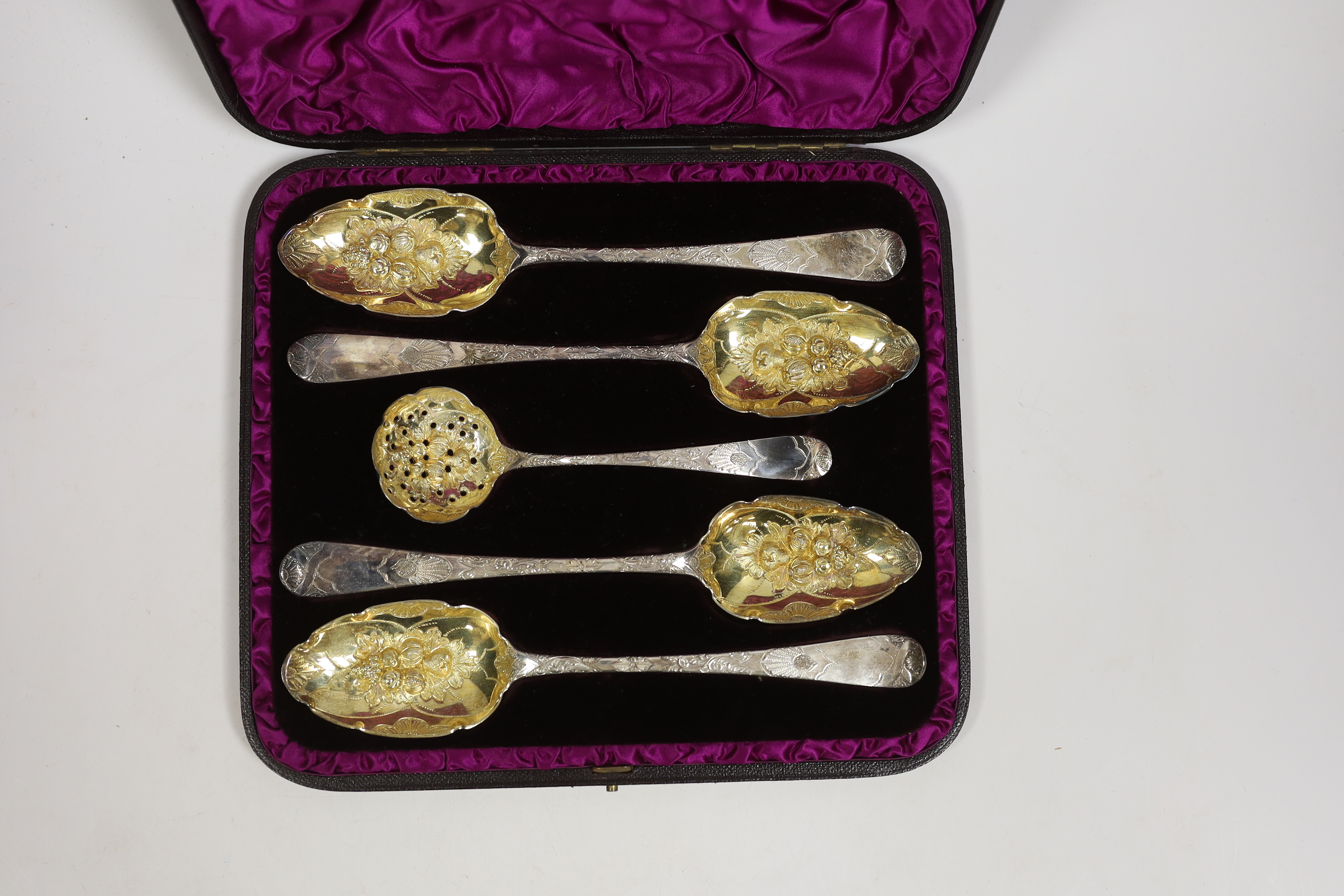 A cased George III matched silver five piece serving and sifter berry spoon set, two spoons by Eley, Fearn & Chawner, London, 1809, serving spoon 22cm.